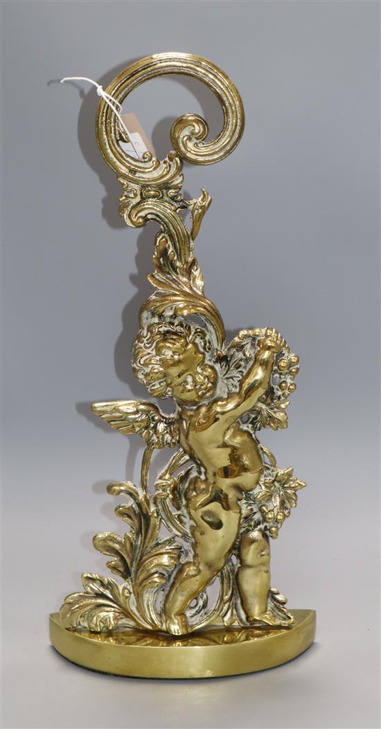 A brass putti door stop 49cm high